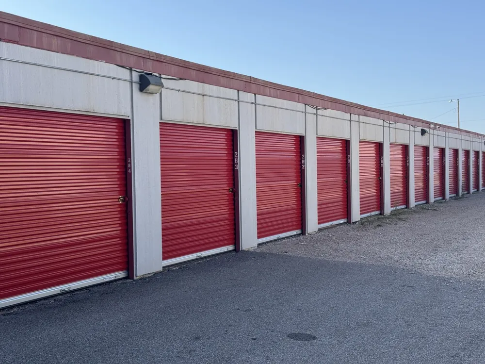 Row of red roll-up storage unit doors at Yukon Self Storage in Yukon, OK